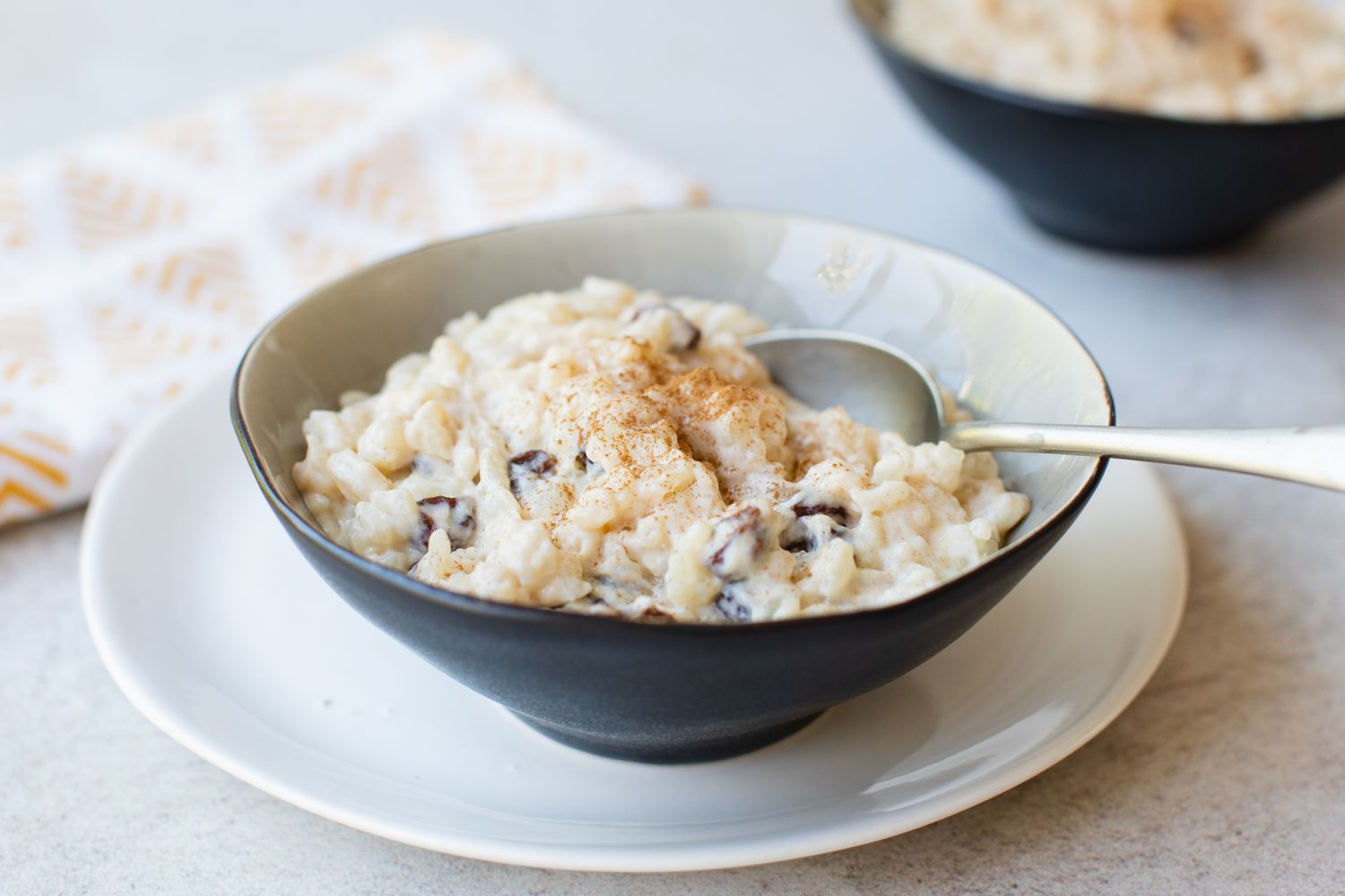 A bowl of stovetop Rice Pudding with raisins