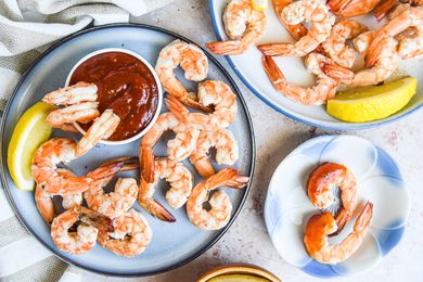 Shrimp Cocktail on a plate with cocktail sauce and lemons