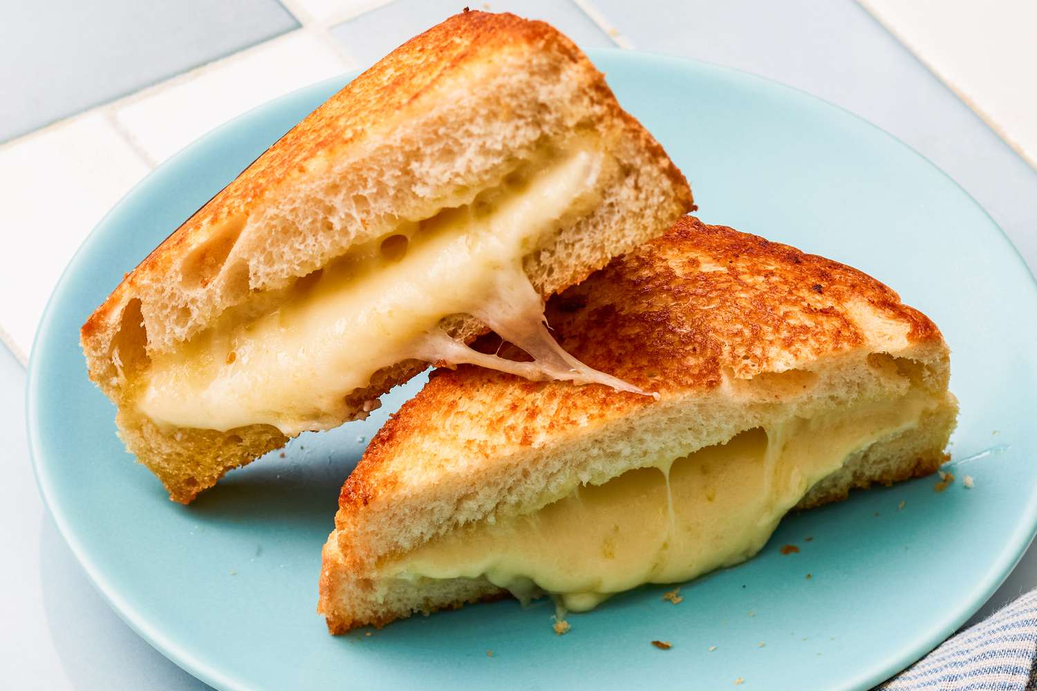 gooey grilled cheese sandwich on a plate