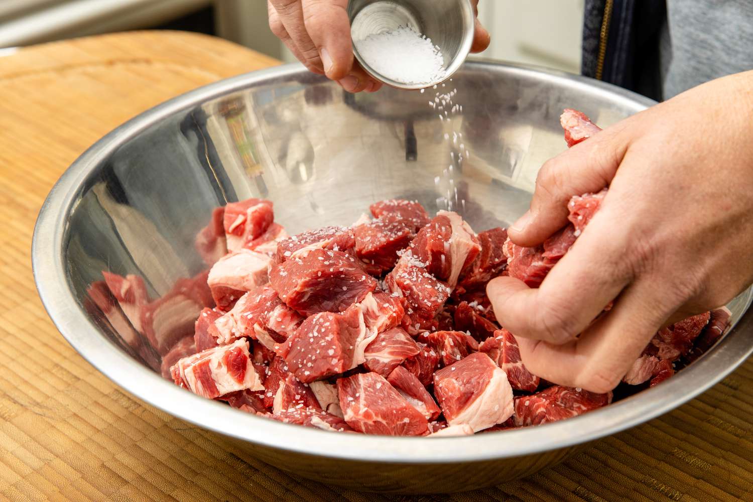 Bowl of Beef Chuck Seasoned with Salt and Massaged in for Easy Beef Stew Recipe