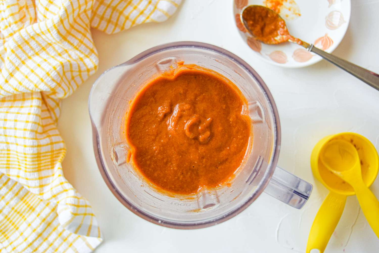 Overhead view of a glass measuring cup with sauce to make pulled pork.