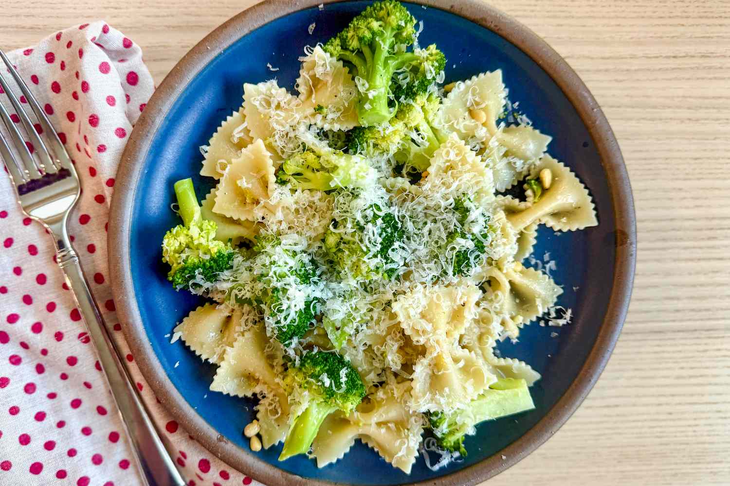 Overhead shot of a blue plate with Ina Garten's broccoli and bowtie pasta recipe