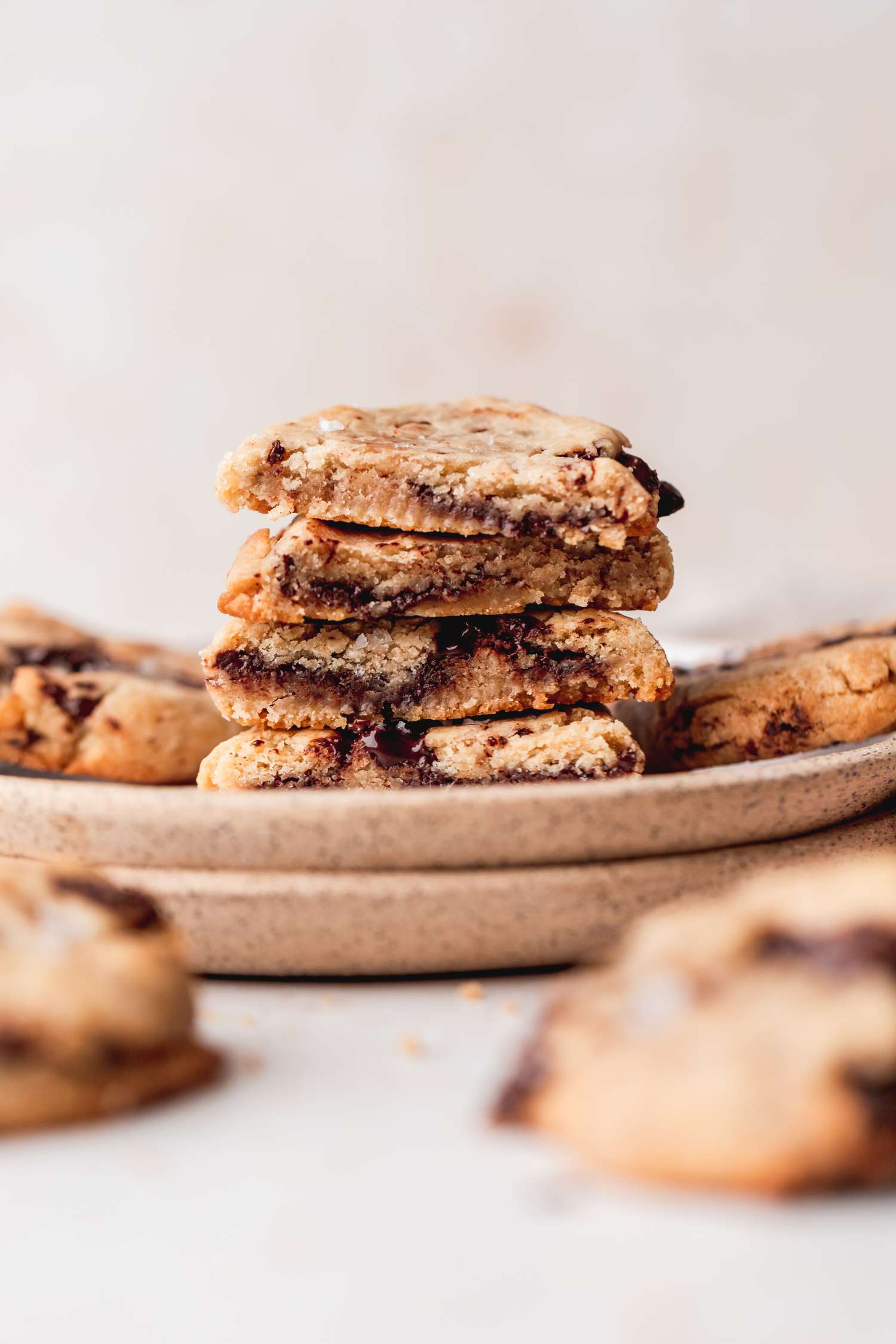 Side view of a stack of vegan chocolate cookies stacked on a plate.