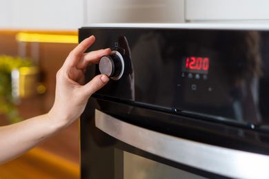 Someone turning on the oven