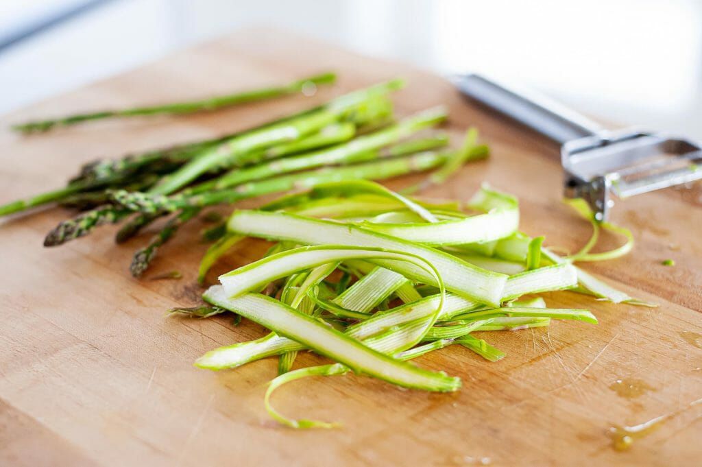 shaved asparagus on a cutting board