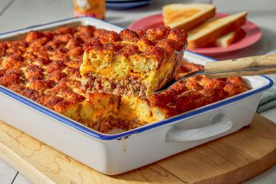 Slice of corned beef casserole lifted from casserole dish using a spatula