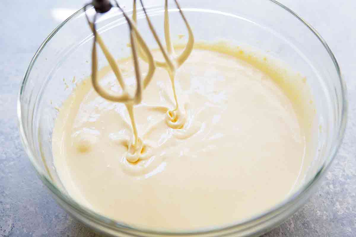 egg yolks being beaten with sugar