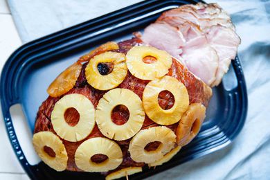 How to Cook a Ham Bone-In - partially sliced ham covered in pineapple rings
