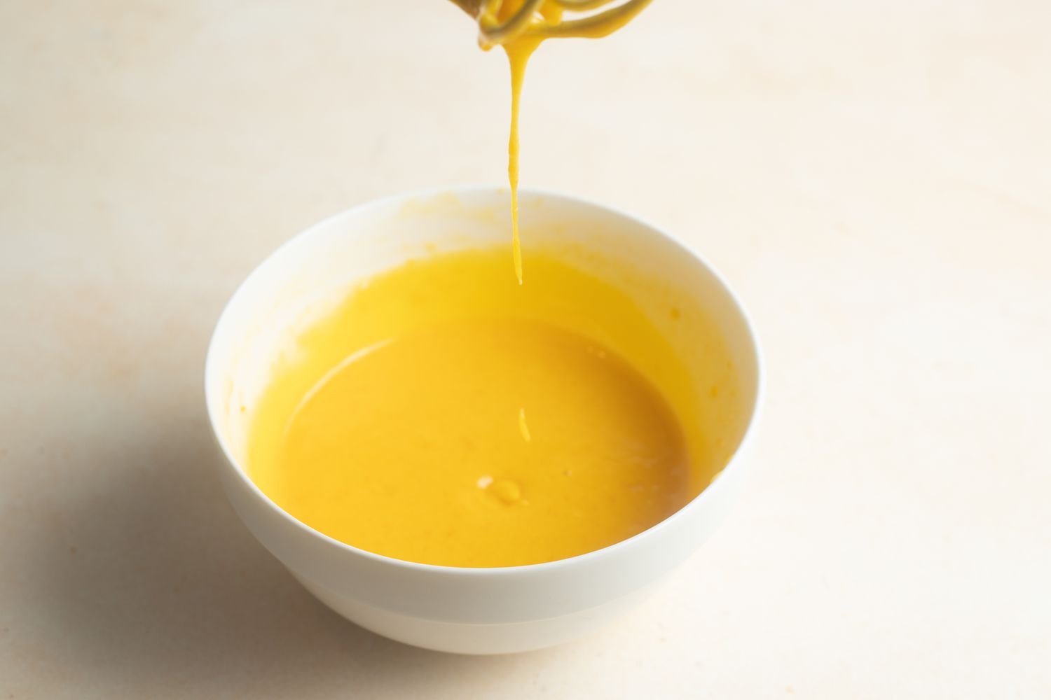 Bowl of Egg Yolks with Some Falling of a Whisk for Chocolate Pots de Crème Recipe