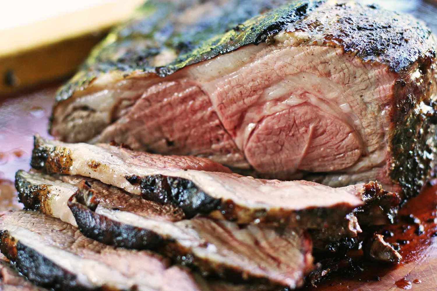 Grilled Butterflied Leg of Lamb sliced on a cutting board