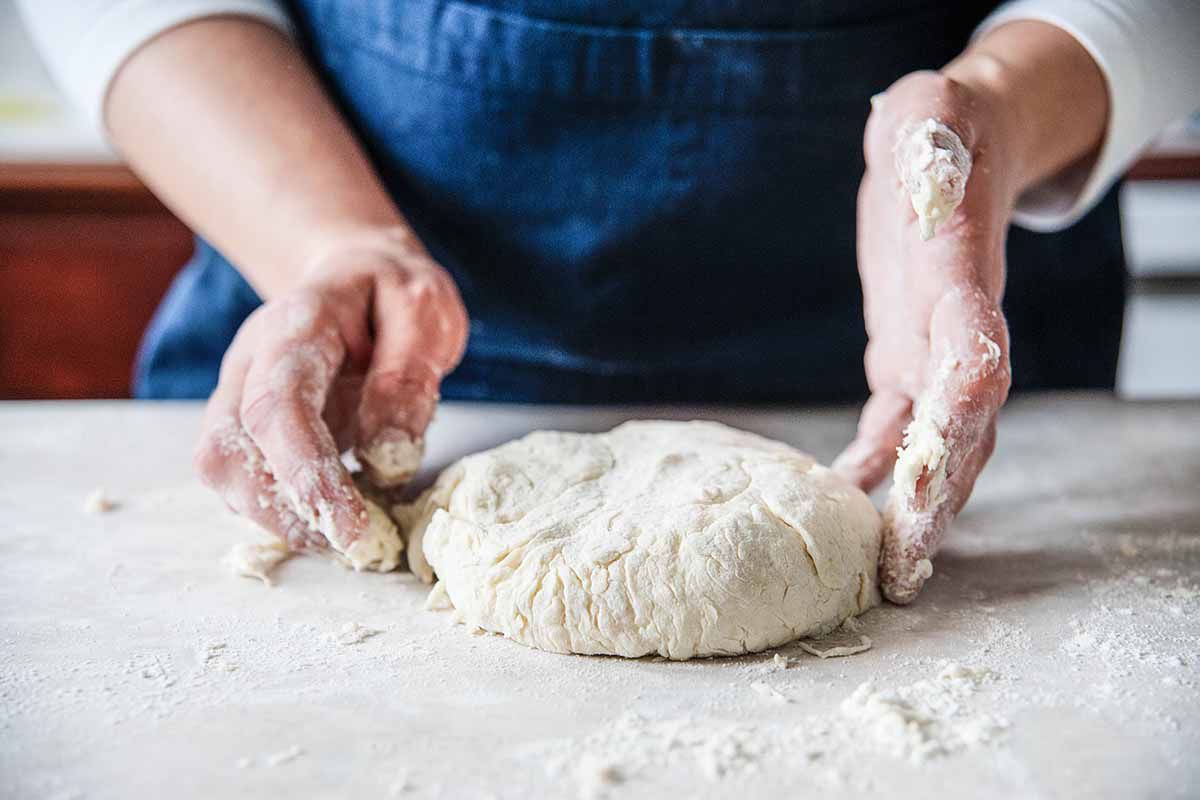 Southern buttermilk biscuits - woman forming a round of dough