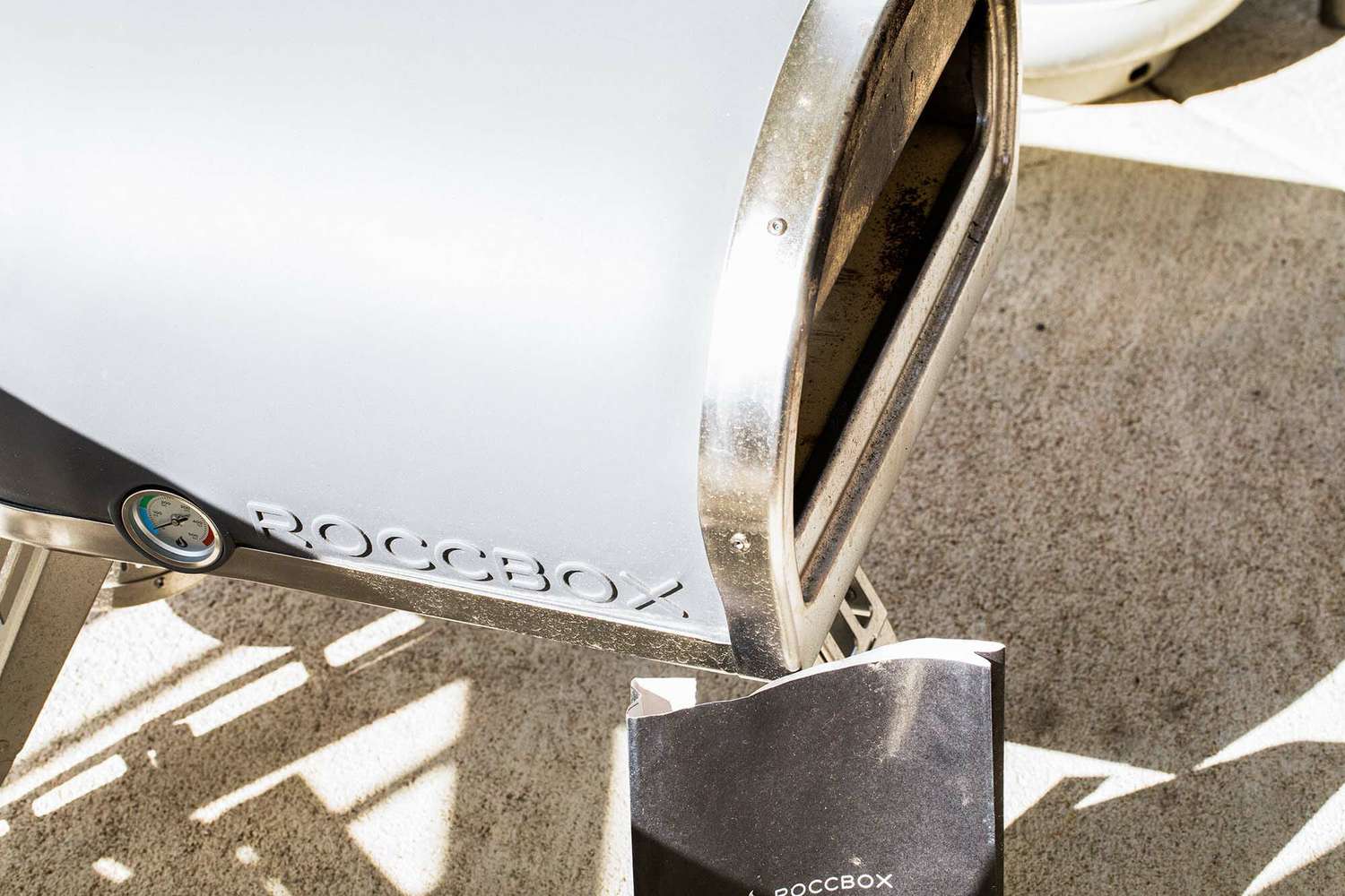 Side view of a Roccbox outdoor pizza oven.