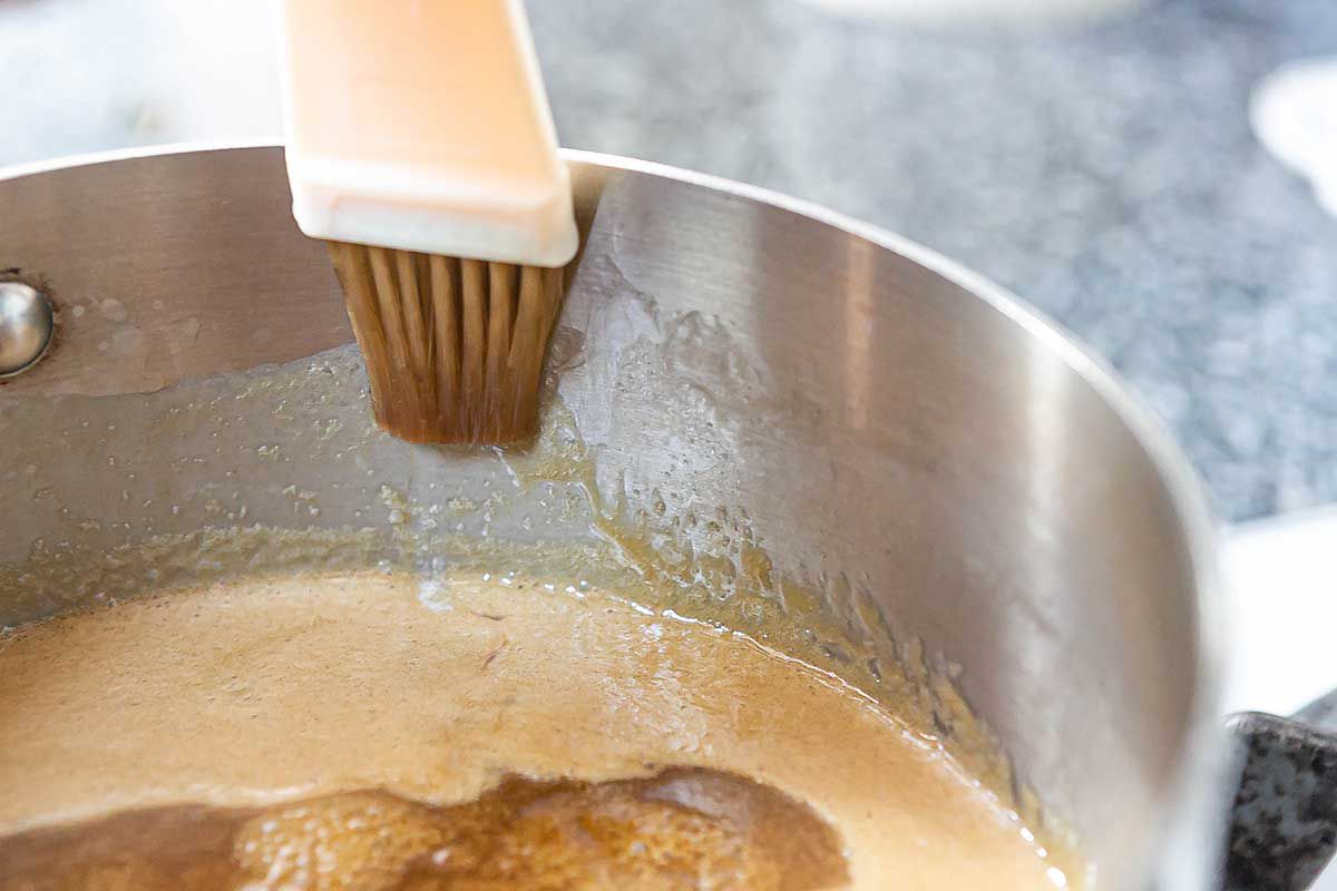 Caramel Apples brushing the sugars down off the side of the pot