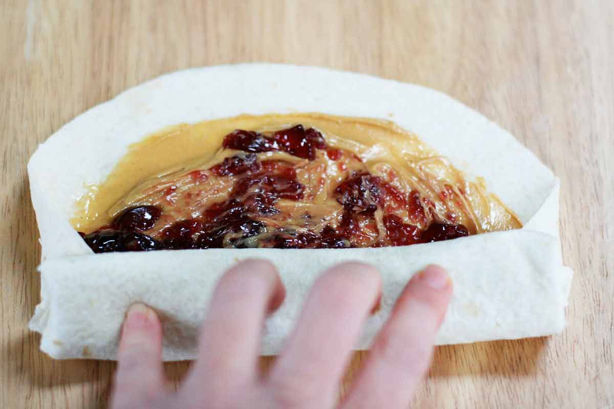 Peanut butter and jelly wrap on a tortilla for kids