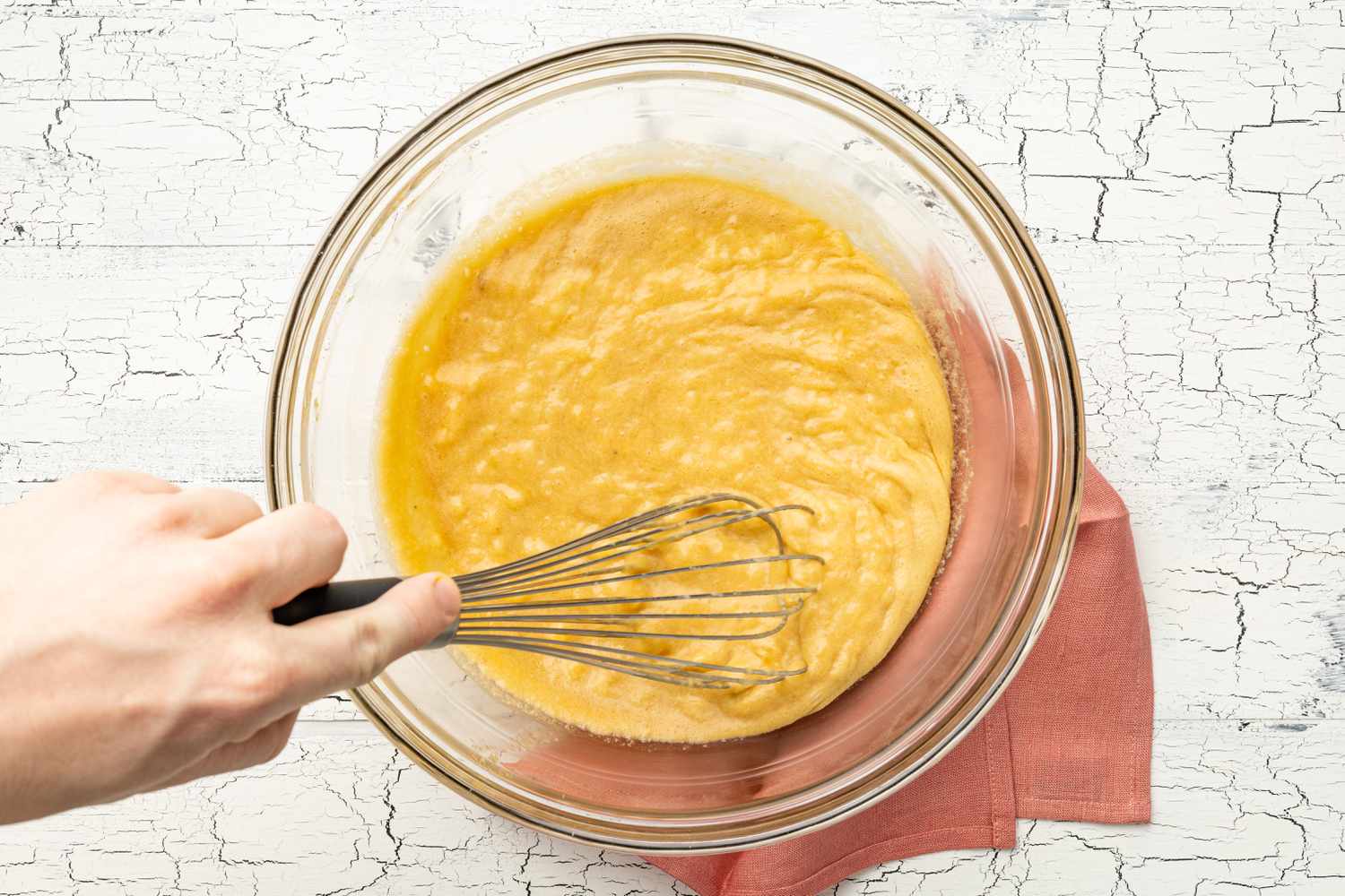 Mashed Bananas Whisked Into Bowl of Wet Ingredients 