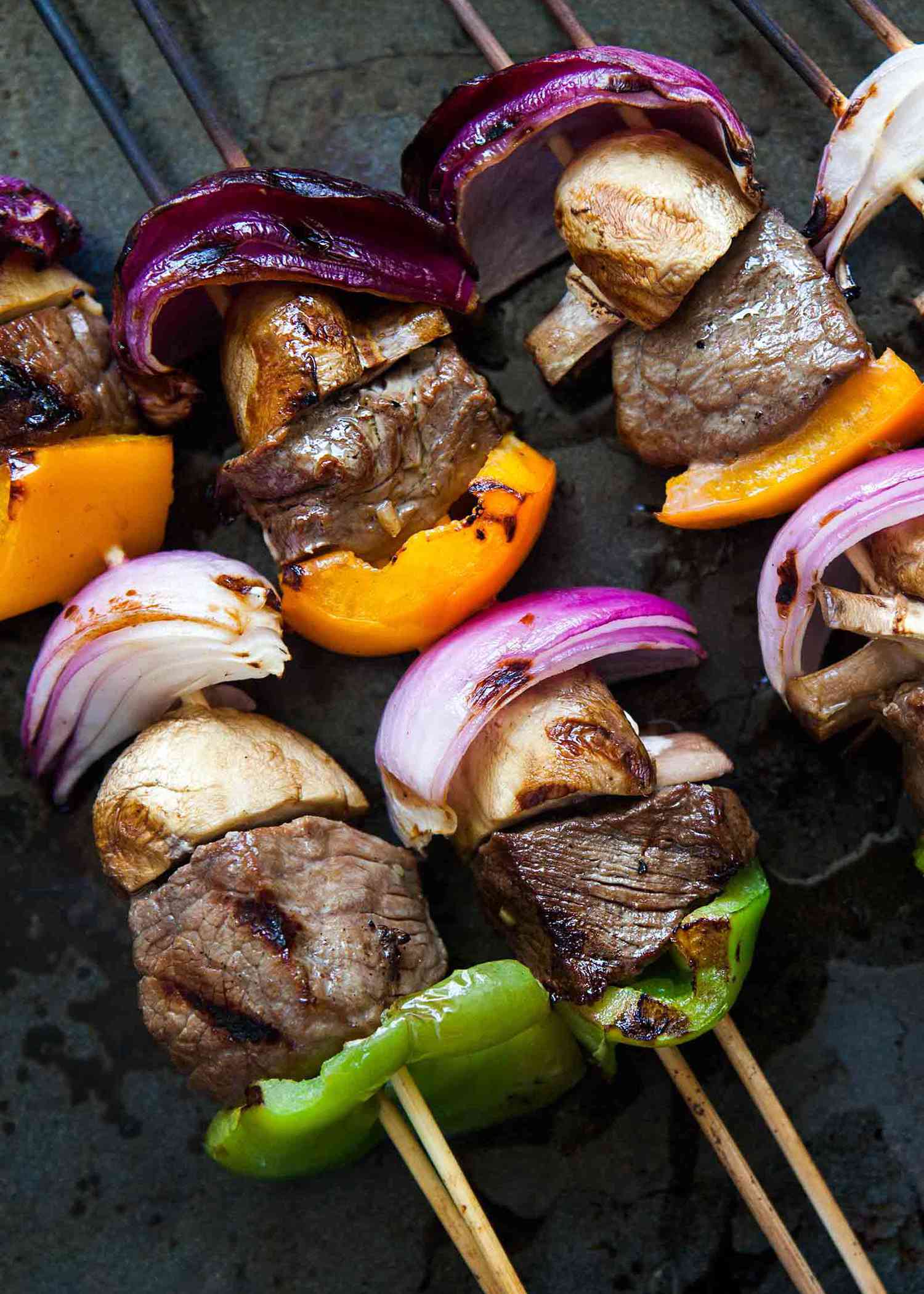 Beef Kabobs with onions, mushrooms, and bell peppers on skewers