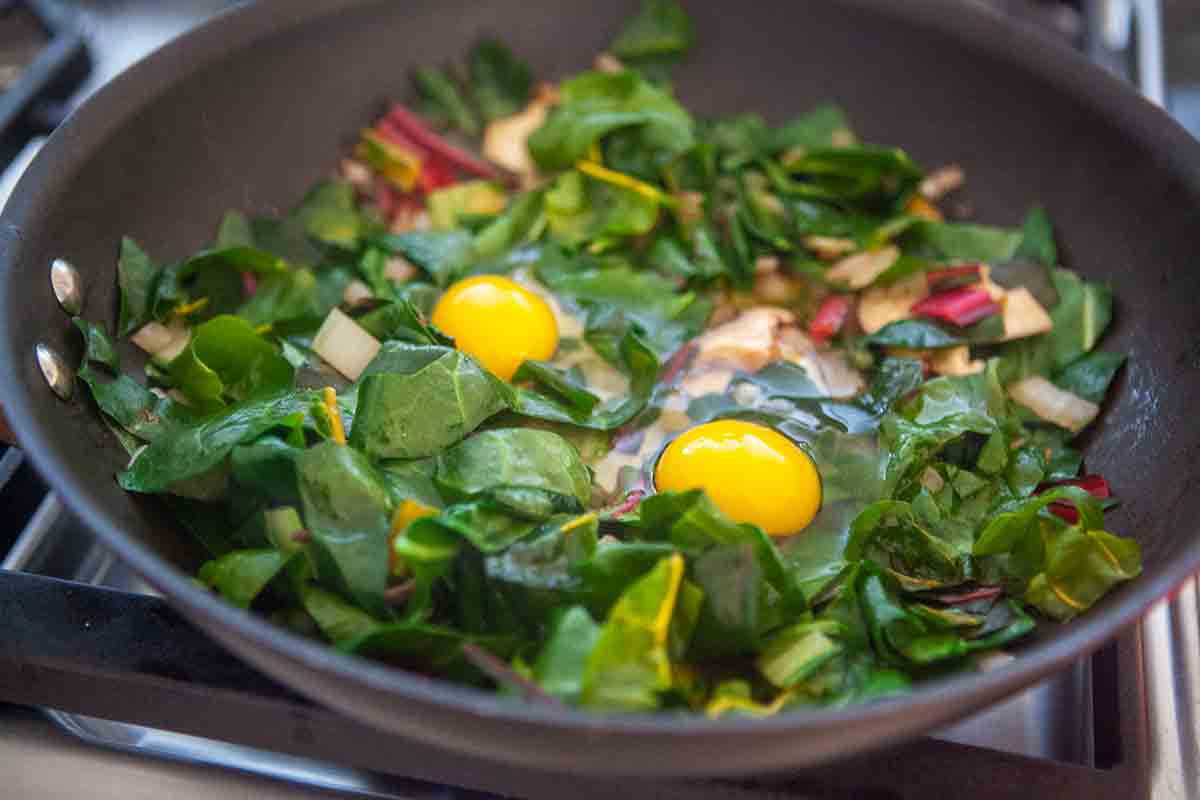 swiss chard raw eggs in pan