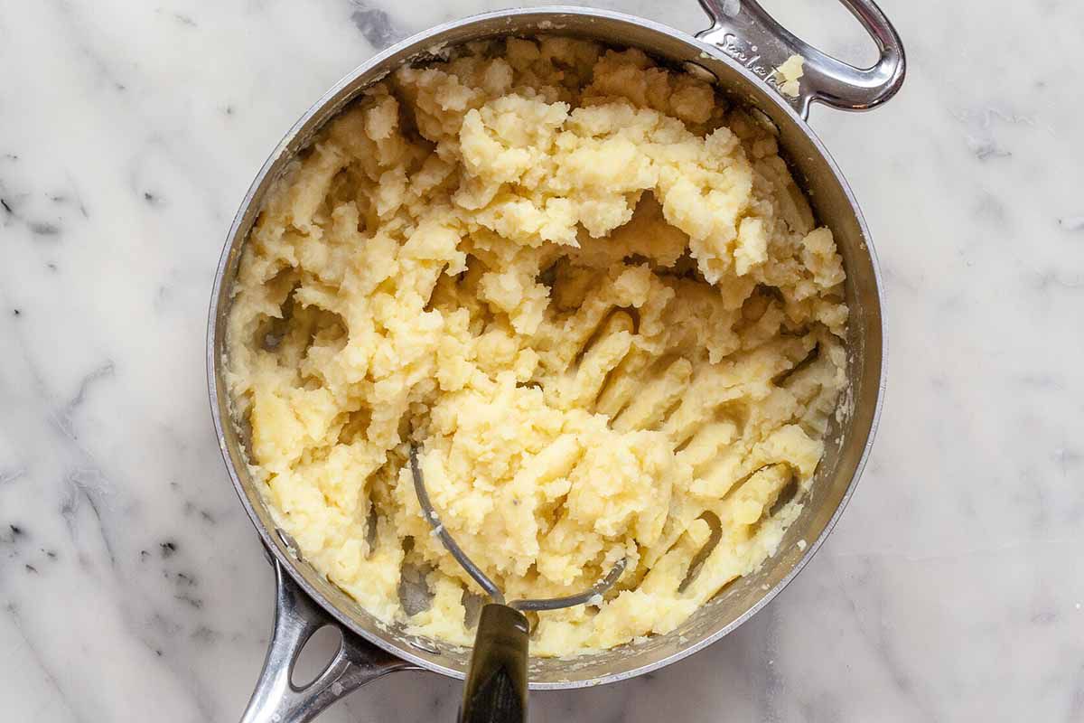 How to Make Cottage Pie - silver pot, potato masher, making mashed potatoes