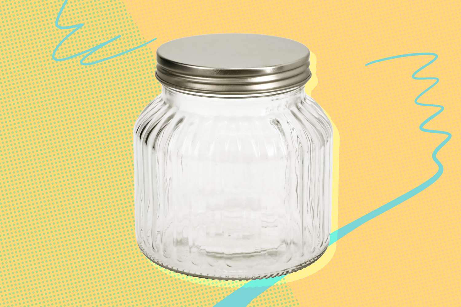 Image of a Dollar Tree Etched Glass Storage Jar over a green and orange speckled background