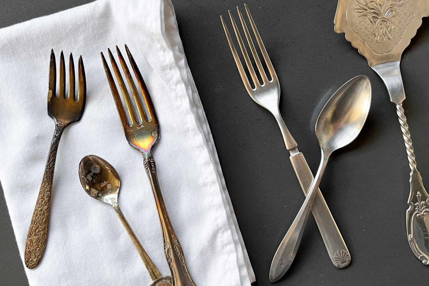 Tarnished Silver on the a Table Napkin and Polished Silver on the Counter for How to Clean Silver