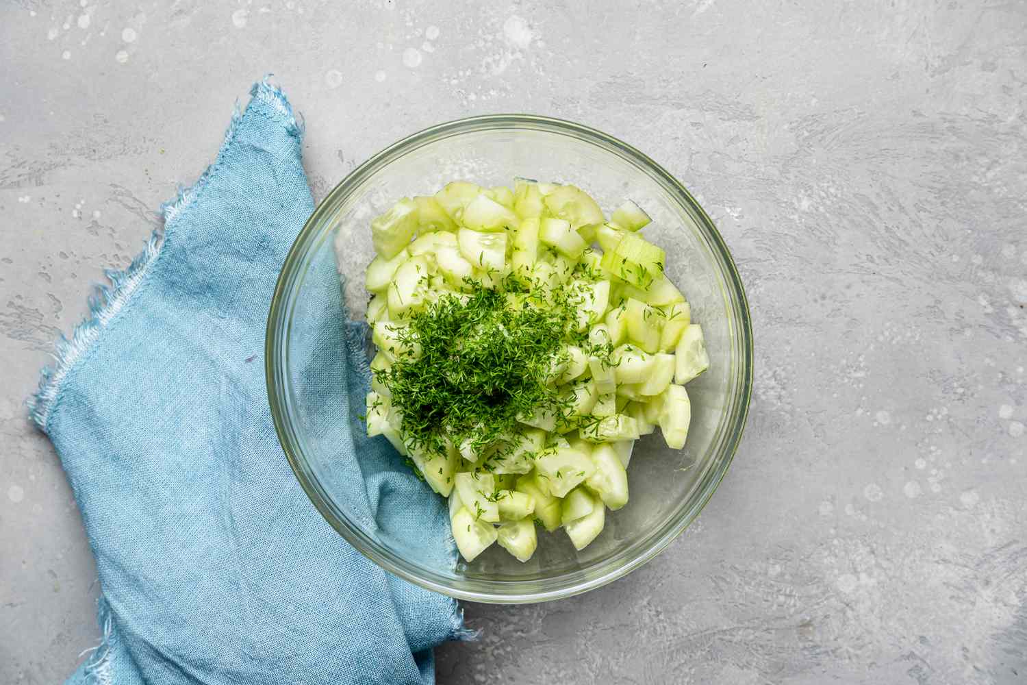 Herbs and Fresh Cucumber in a bowl for a cucumber salad recipe