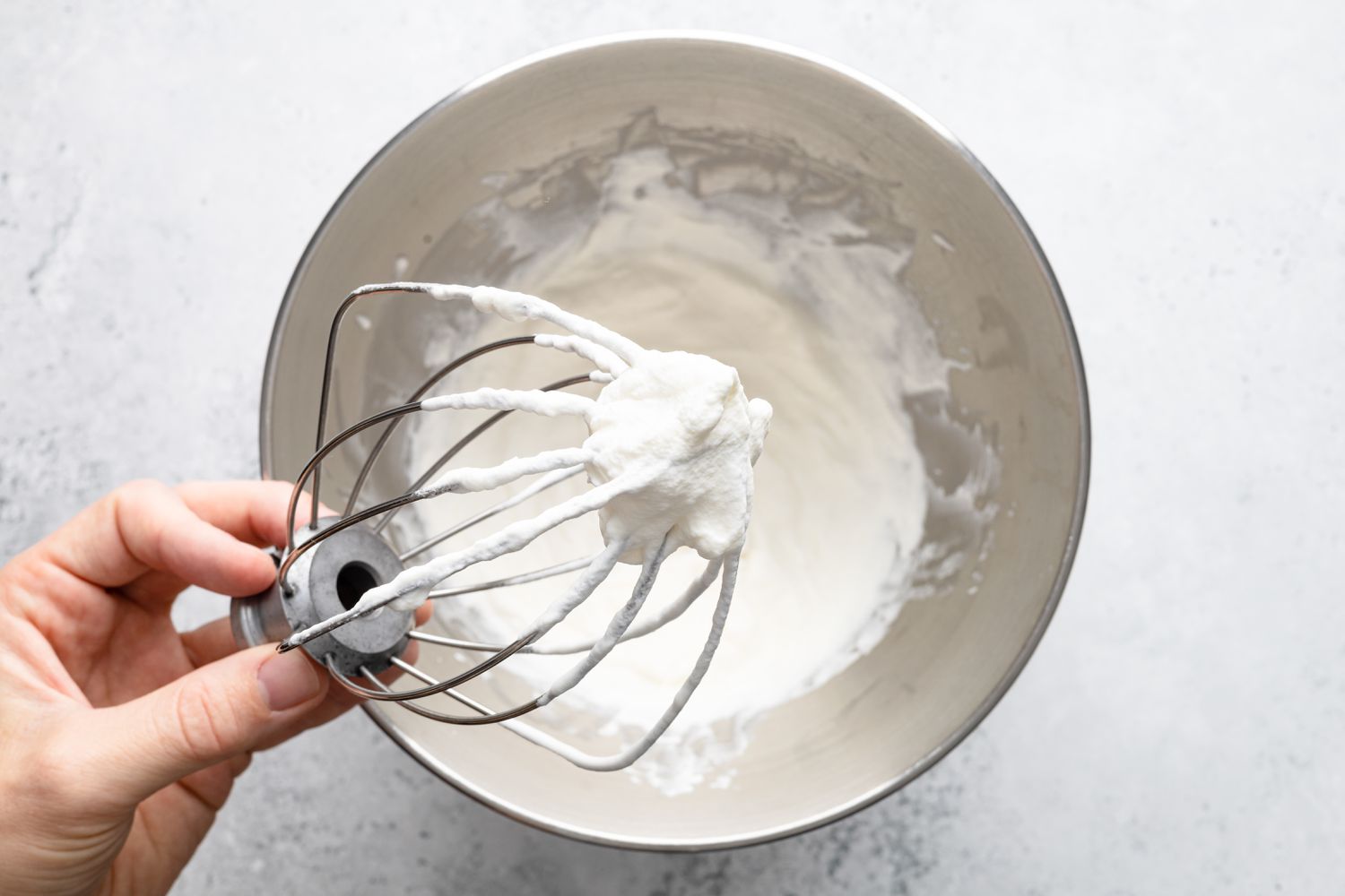 Whipped Cream on a Mixer Whisk Attachment and Mixing Bowl for Bee Sting Cake