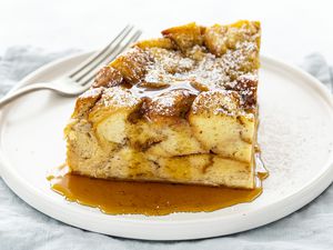 Slow Cooker French Toast Casserole Recipe - slice french toast casserole on plate with syrup and fork