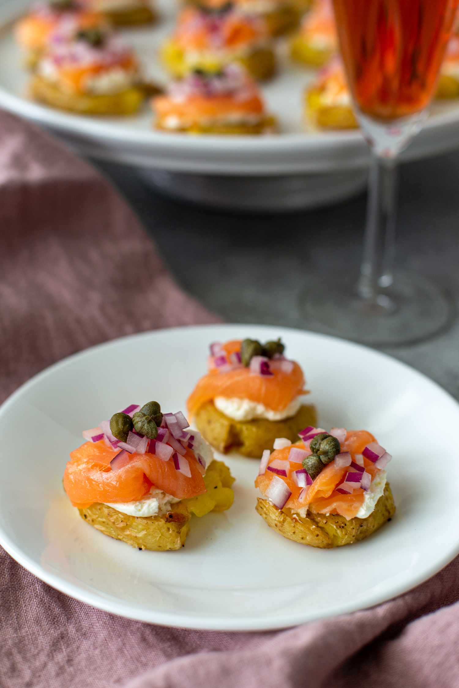 A plate of three smoked salmon-topped potatoes