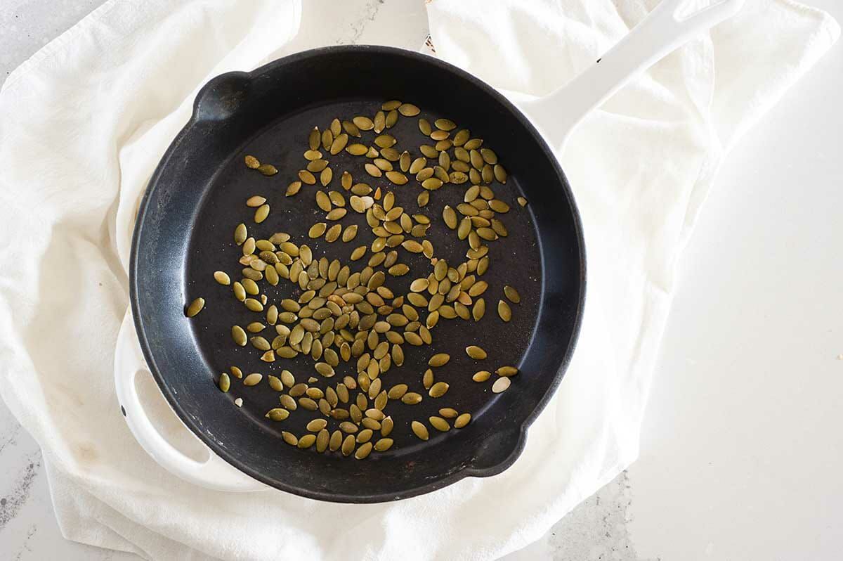 Pumpkin seeds toasted in a non-stick skillet for Dairy-Free Pumpkin Bread.