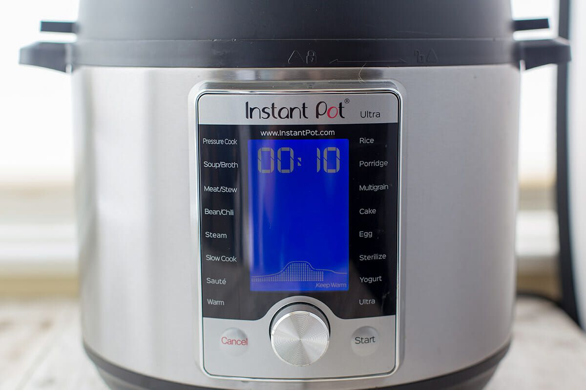 An Instant Pot Ultra with a digital display reading to 10 minute programmed time