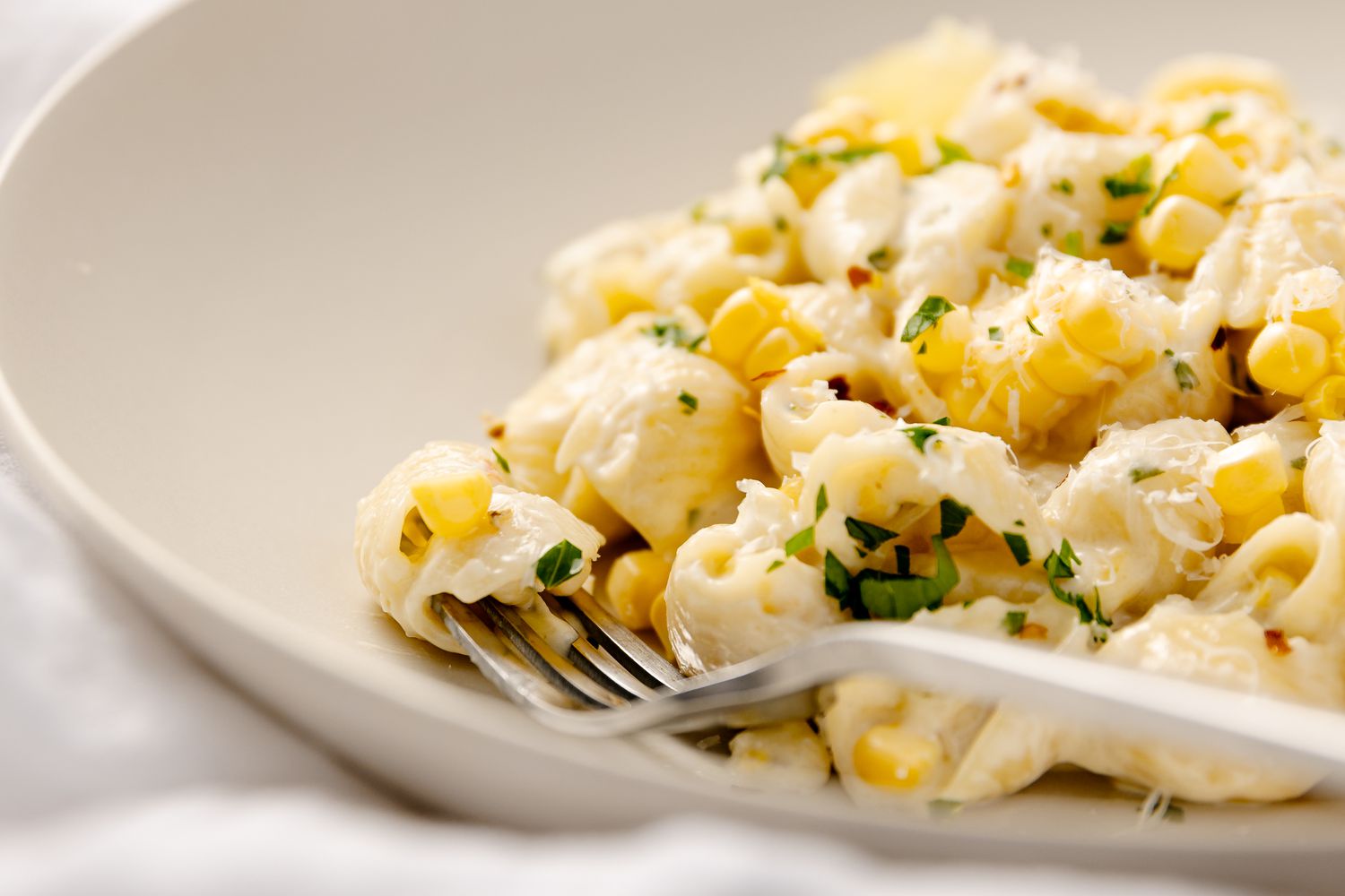 Bowl of Fresh Corn Pasta with a Fork