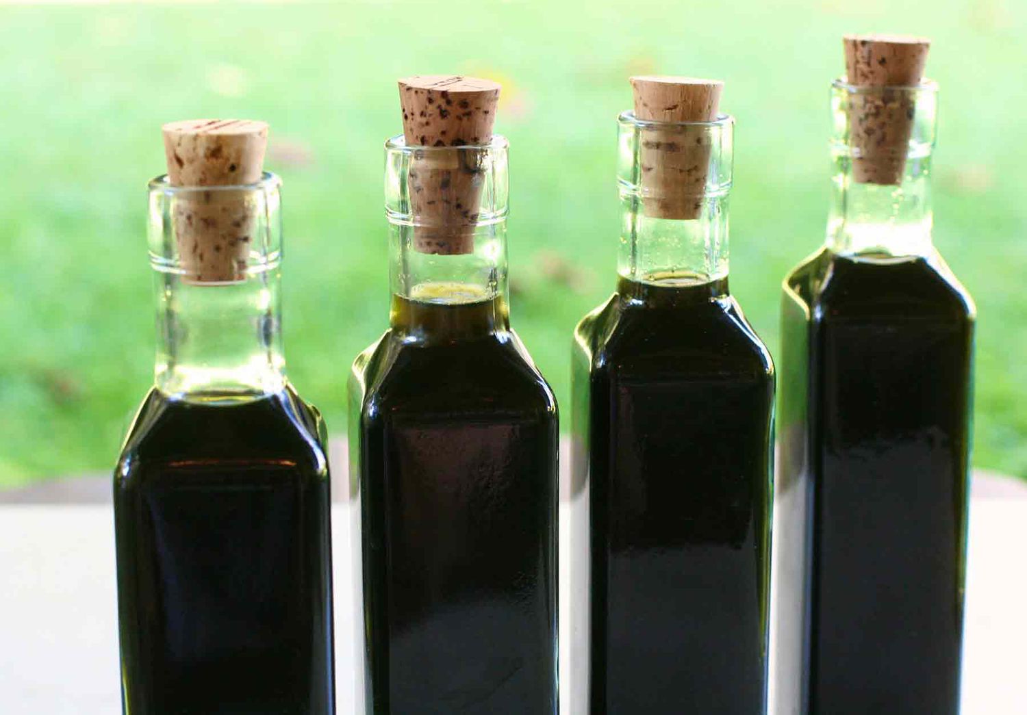 Homemade Nocino walnut liqueur in bottles with cork stoppers