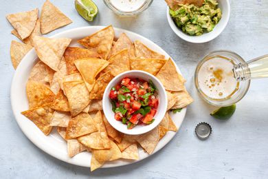 A plate of tortilla chips and beer