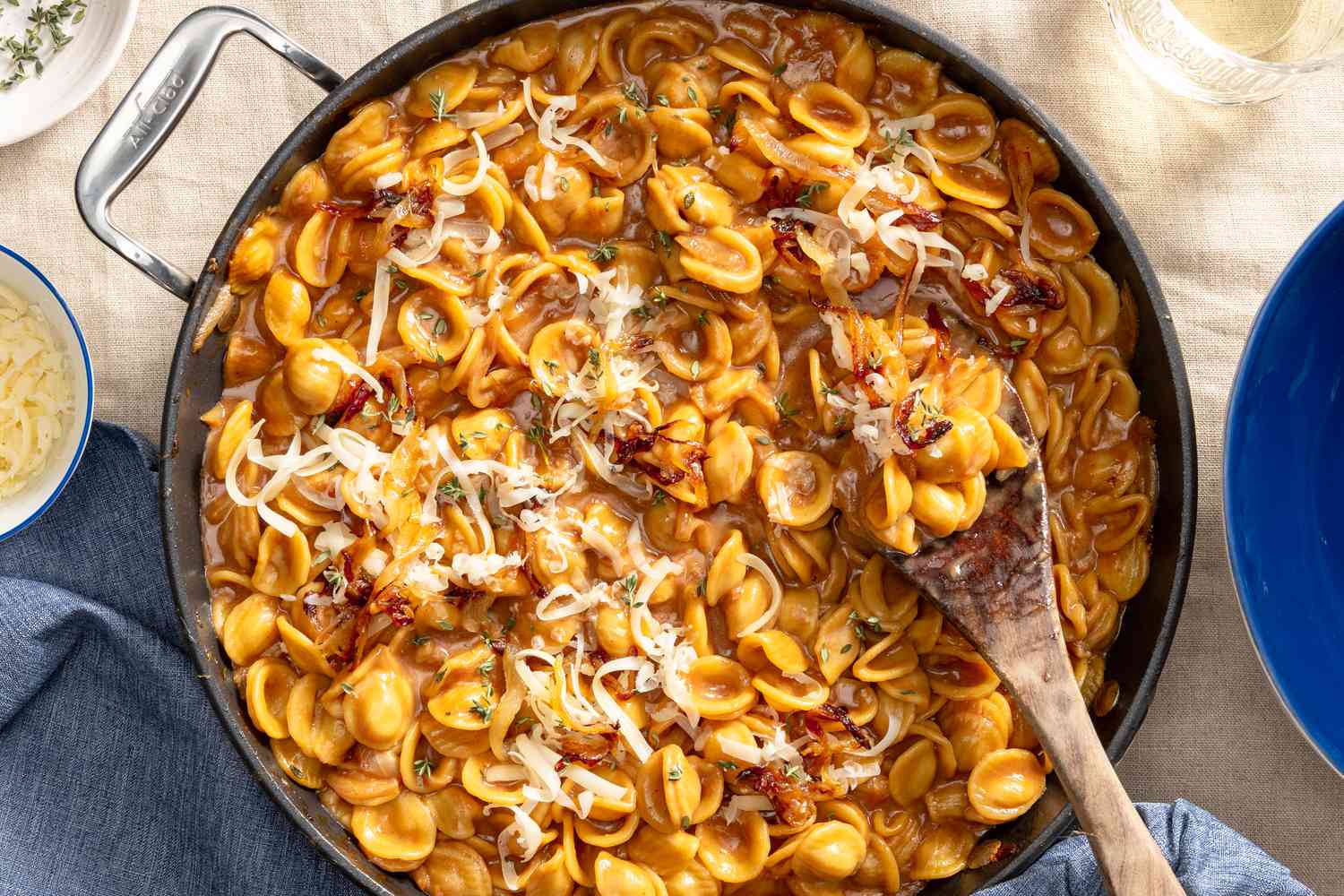 French onion pasta in a pot at a table