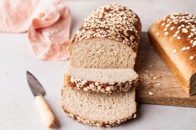 Front view of a loaf of a partially sliced loaf of oat bread 