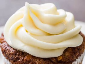 Cream cheese frosting piped on a cupcake