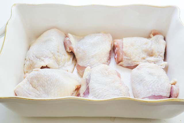 bone in skin on Chicken thighs in a dish