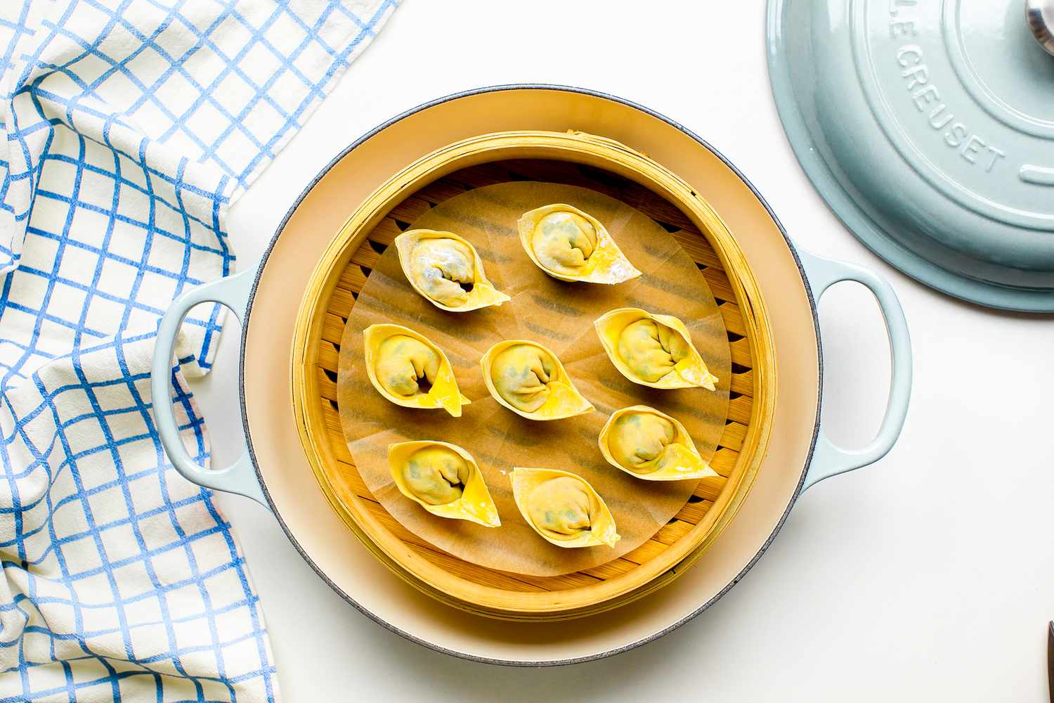 Pork and Chive Dumplings in a Lined Bamboo Steamer in a Dutch Oven