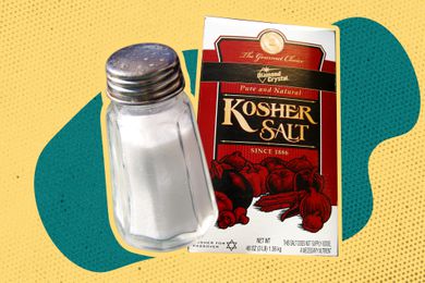 Table salt shaker and a box of kosher salt on a blue and yellow colorblock background