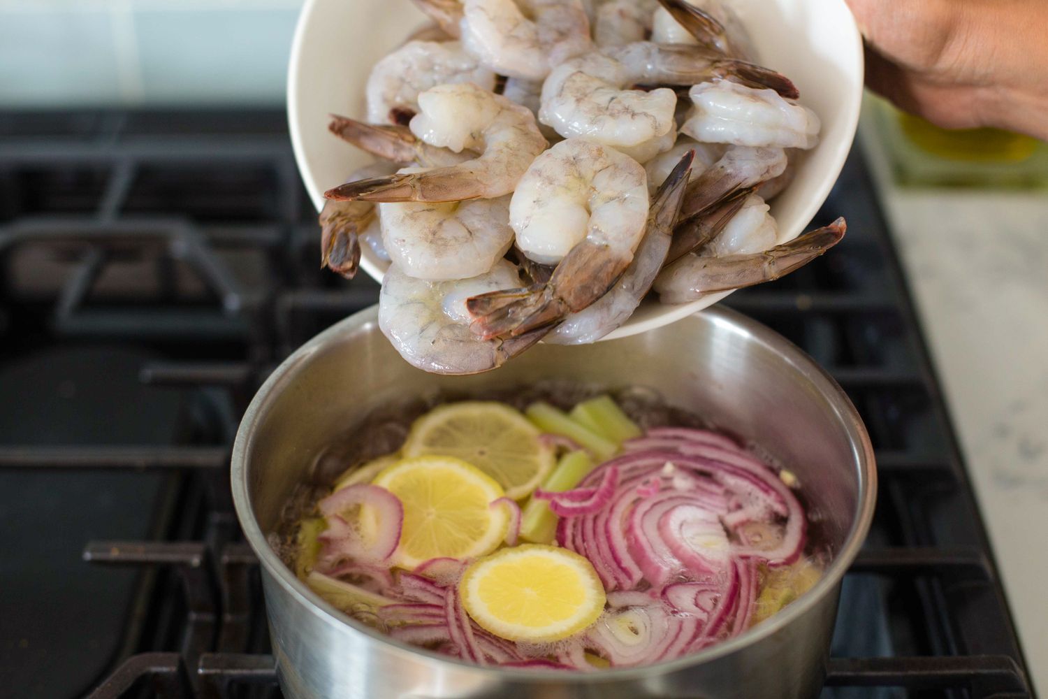 Bowl of Shrimp Added to Pot of Lemon and Onions