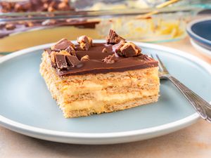 Peanut Butter Éclair Cake on a dessert plate with a fork