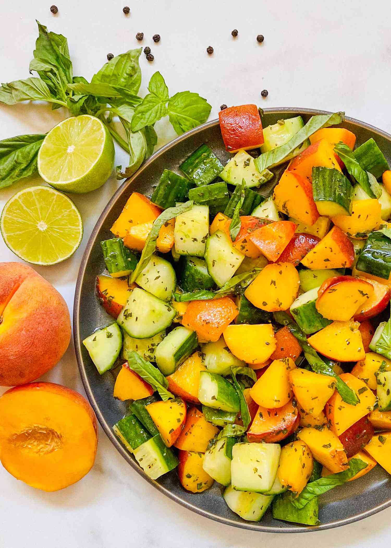 Peach, cucumber, and basil salad in a bowl, ready to serve