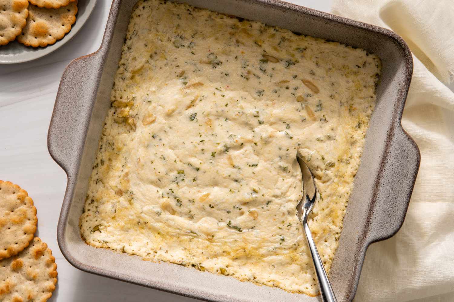 Square pan filled with a crab dip recipe