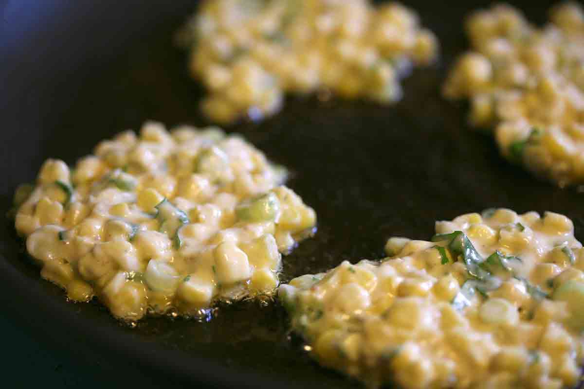 dollop corn fritter batter into hot pan