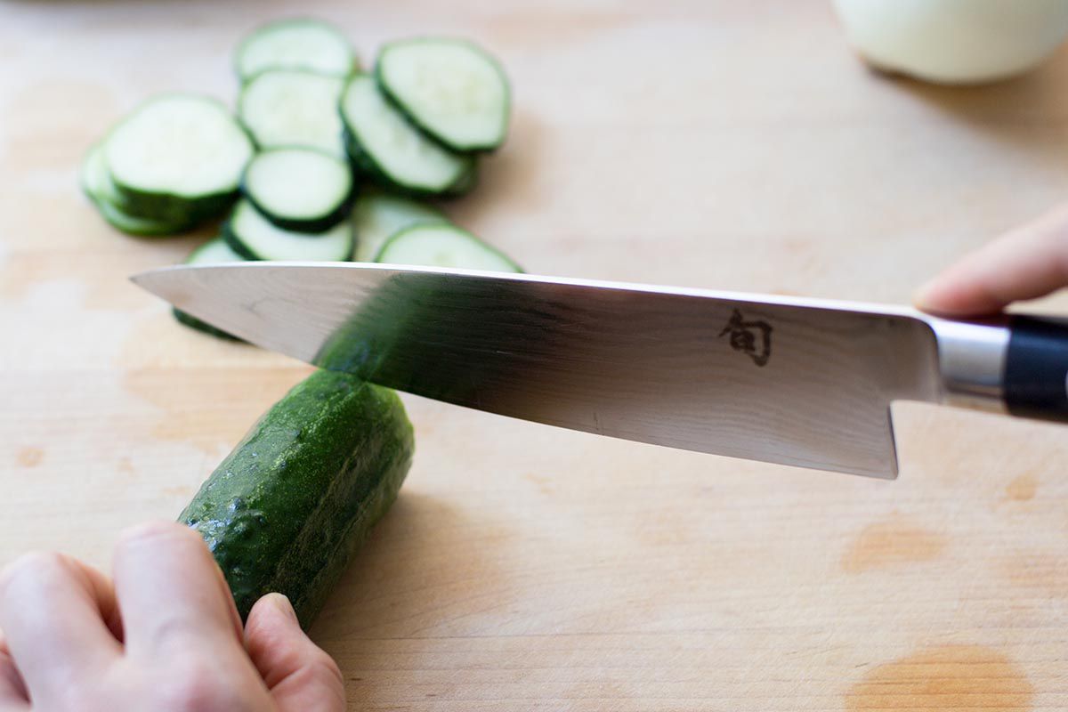Slice the cucumbers very thin for making refrigerator piclkes