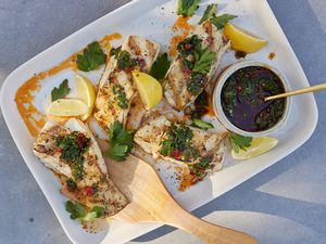 Plate of Grilled Halibut with Calabrian Chile Gremolata with Utensils on a Table