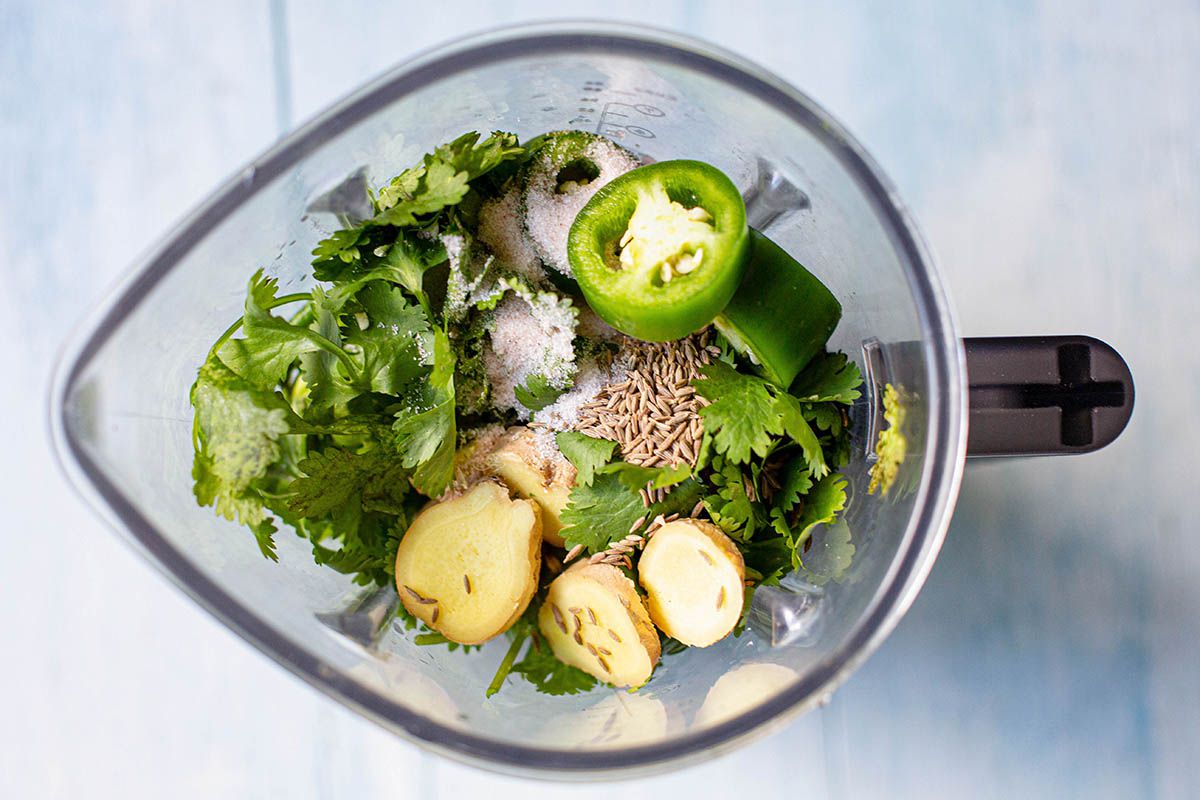 Cilantro, mint, lemons, cumin, ginger, garlic and jalapenos in a blender.