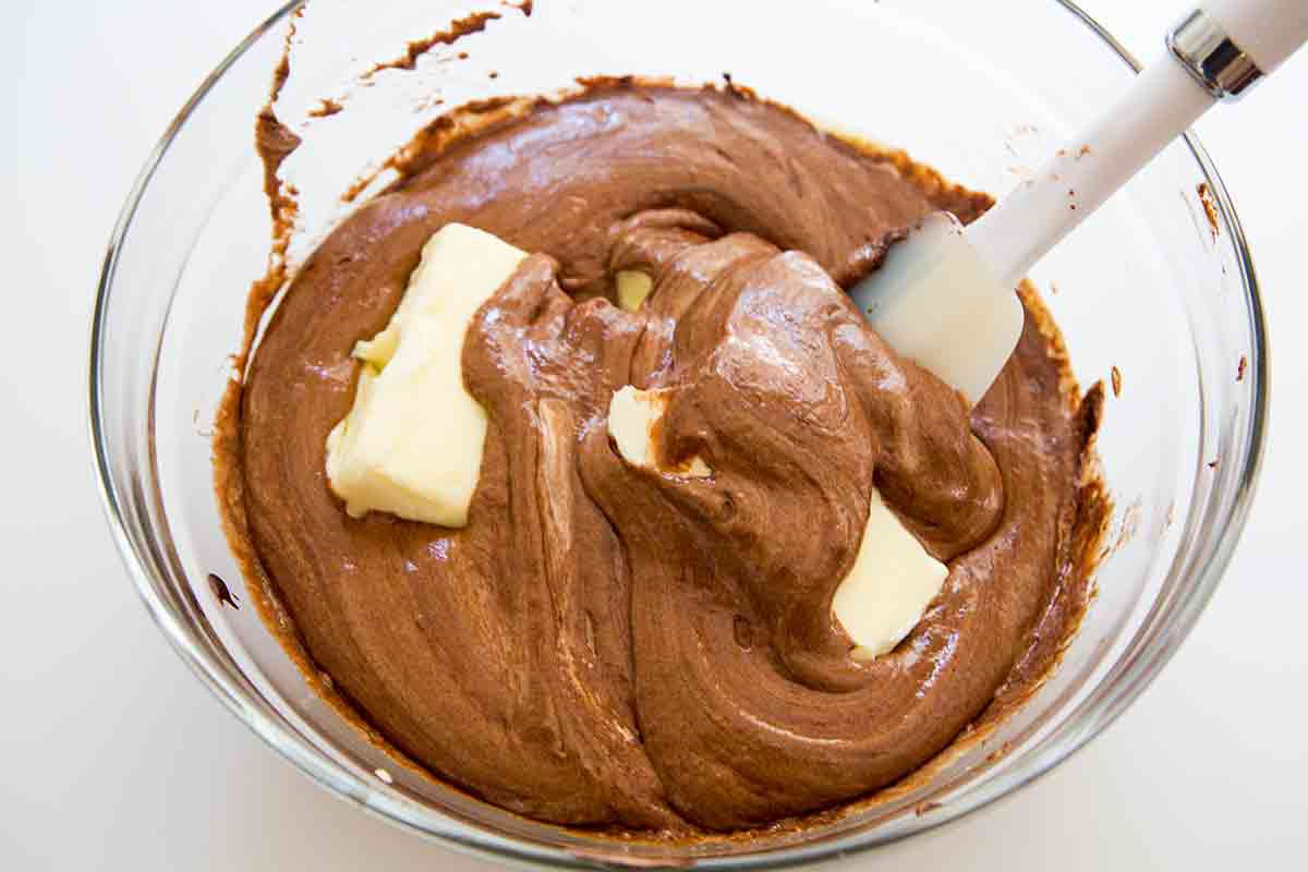 mixing softened butter into bittersweet chocolate cake batter