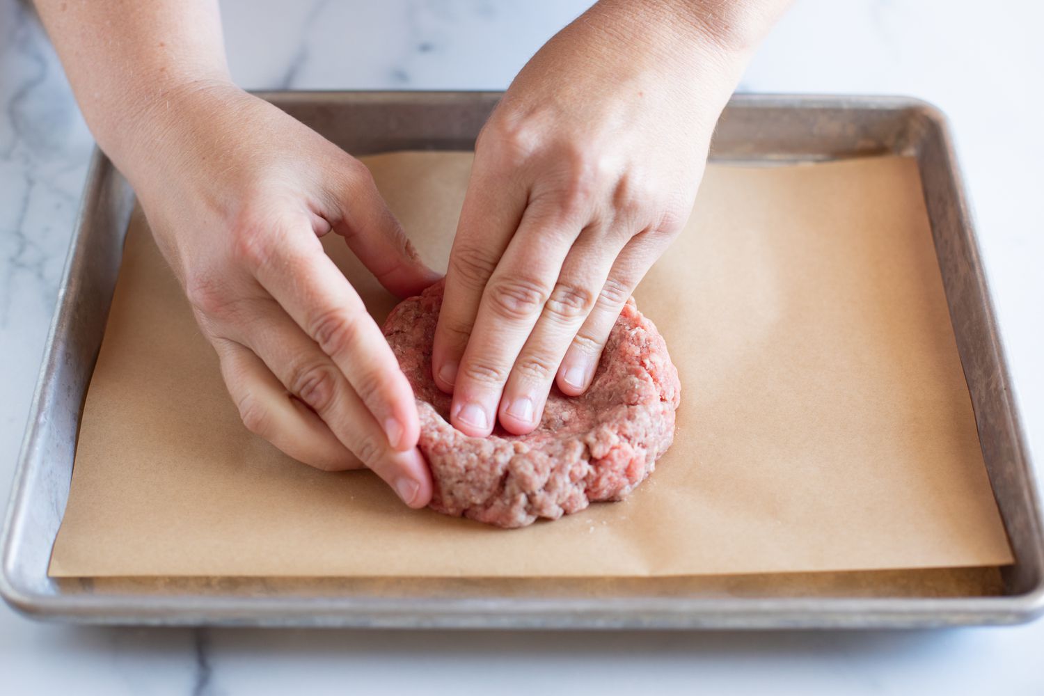 How to shape burger patties using hands and pressing.