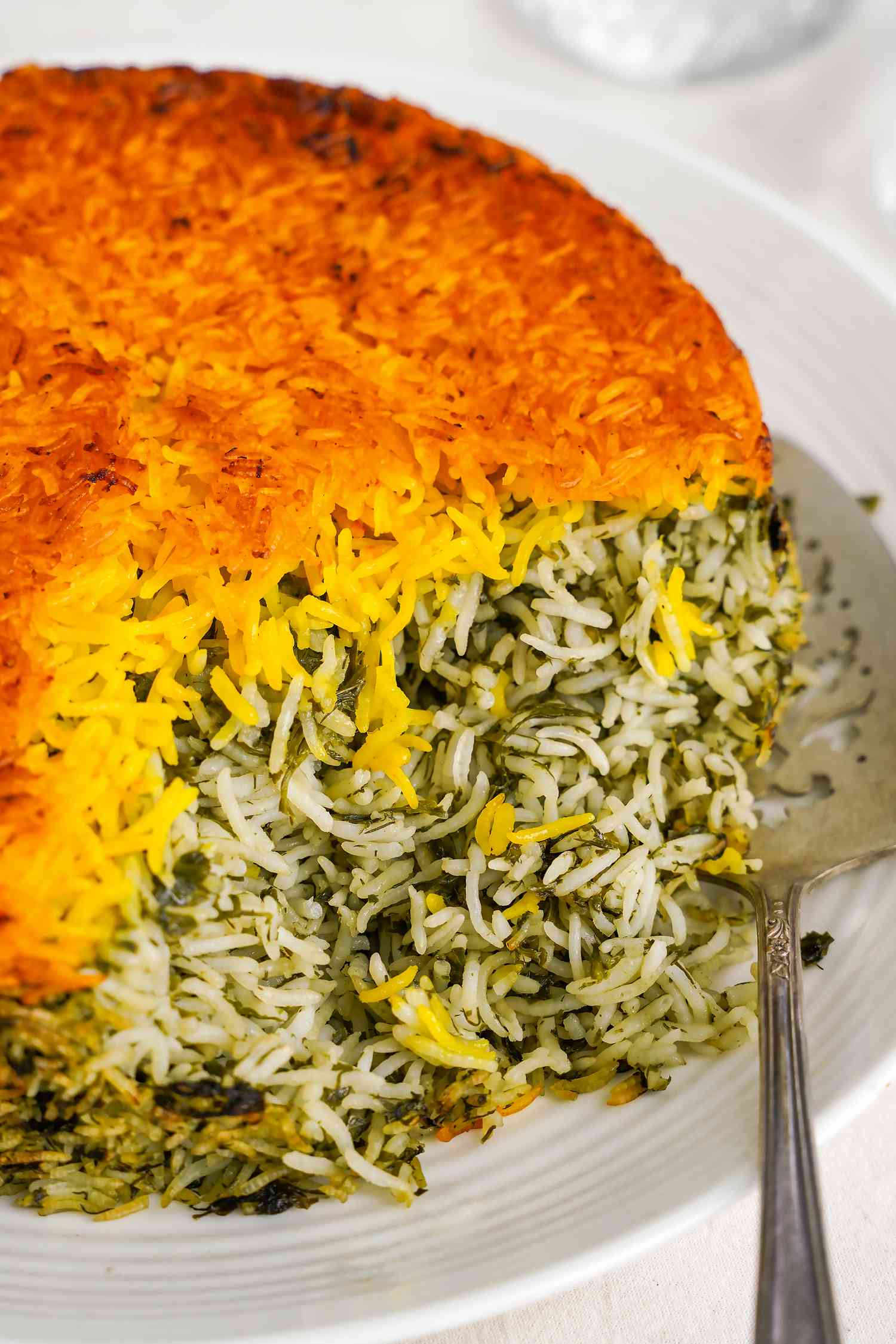 Sabzi Polo (Persian Herb Rice) on a Plate With a Serving Spoon 